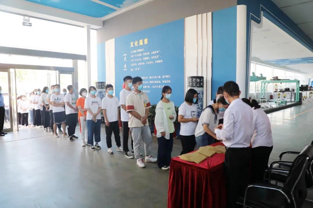 Students line up to receive bursary